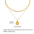 Detailed view of layered 18K gold conch shell pendant with snake and bead chains - Gold
