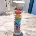 Colorful Rainmaker percussion toy with rainbow beads in a transparent hex tube - Extra Large Rainmaker (Hexagon)