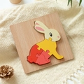 Wooden rabbit 3D puzzle toy for kids with natural wood base on warm knit background - Rabbit
