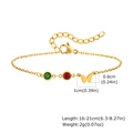 Detail showing the gold butterfly charm with red and green cubic zirconia on a link chain - Gold