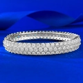 Macro shot of three-row eternity band with micro-paved clear stones on a silver-tone ring - 1.7cm / Silver