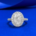Luxury halo ring with oval-cut 7x10mm cubic zirconia on a minimalist navy background - US 5 / White Zirconia Pigeon Egg Style (R1502)