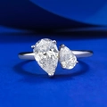 Elegant 925 sterling silver ring with double pear-shaped white stones on blue backdrop - US 5