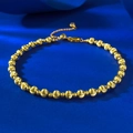Dettaglio del bracciale a sfere dorate con perle opache e lucide su sfondo blu - Regolabile / Oro Piccolo 4.0mm