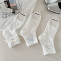 Detailed close-up of white mesh cotton socks with lace bows and button decorations - One Size / Mixed Colors