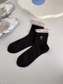 Detail of black mesh socks with pink plaid cuff and white bow embroidery decoration - Black