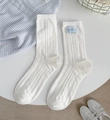 White ribbed crew socks featuring a light blue cartoon bear tag with bear doll graphics - Blue Label