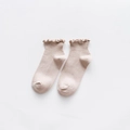 Short beige ribbed socks for women featuring elegant ruffle cuffs and sweet minimalist style - One Size / Nude