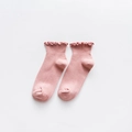 Pink rib-knit children socks with elegant ruffle lace trim shown in flat lay - One Size / Pink