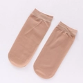 Short skin-toned nylon socks with elastic cuffs, presented on a clean white background - One Size / Deep Skin