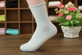 Mint green rolled edge combed cotton socks for women shown on a foot model - One Size / Light Blue