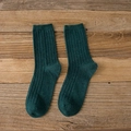 Dark green ribbed rabbit wool blend crew socks for women shown on a wooden background - One Size / Dark Green