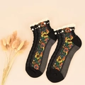 Retro black knit crew socks with colorful floral patterns and pearl lace trim detail - One Size / Black