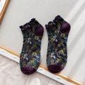 Purple floral knit socks with frilled cuffs and contrasting toe on a wooden frame - Purple