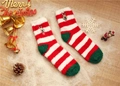Close-up of fluffy Christmas socks with reindeer embroidery and festive bells decor - Size 37-42 / Red White Striped Reindeer