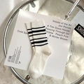 White crew socks featuring black stripes and rib knitting on a textured background - One Size / White with Black Stripes