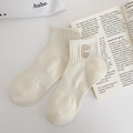 Detailed view of cream cotton knit crew socks with khaki embroidered C letter and ribbed texture - One Size / Off-White (Letter C)