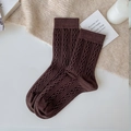 Thick dark brown cable knit wool socks for women in a cozy winter lifestyle setting - One Size / Coffee