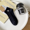 Black cotton low-cut socks featuring white smiley face embroidery and ribbed texture - One Size / Black