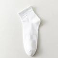 Single white mid-calf cotton sports sock with premium ribbed texture on leather surface - One Size / White