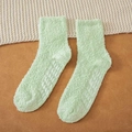 Soft light green coral fleece winter socks with non-slip grippers on a cozy background - One Size / Autumn Green