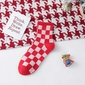 Festive red and pink checkered crew socks with ribbed cuffs in a cozy winter setting - One Size / Red Plaid