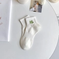 White cotton sports socks with green H embroidery detail in a minimalist aesthetic - One Size / White