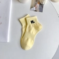 Pale yellow cotton crew socks featuring black H letter embroidery and ribbed cuffs - One Size / Light Yellow