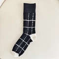 Mid-calf black knit socks with white cable knit grid patterns and contrast heel - One Size / Black Plaid