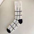 Off-white knit mid-calf socks with black grid patterns and textured cable stitching - One Size / White Plaid