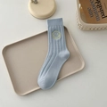 Light blue cotton crew socks with a bright yellow smiley face embroidery detail - One Size / Milky Blue