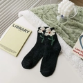 Thick black coral fleece socks featuring white daisy embroidery and plush texture - One Size / Black