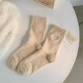 Beige fuzzy mink velvet socks with embroidered hello detail in a cozy home setting - One Size / Milk Tea