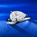 Elegant pear-cut diamond ring in silver-tone finish on a textured blue background - US 5 / Silver