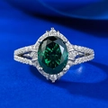 Elegant S925 silver ring featuring an oval emerald green stone in halo setting with split shank - US 5 / Emerald
