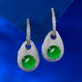 Detail of green jade drop earrings with micro-set diamonds on a blue velvet stand - Green Chalcedony Style (E513) / 925 Silver