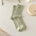 Light green cotton ribbed crew socks with minimalist white fabric label detail - One Size / Milky Green