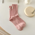 Pink cotton crew socks with ribbed texture and woven label in a soft cream setup - One Size / Sakura Pink