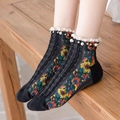 Detail of black knit ankle socks with floral embroidery, white lace, and pearl accents - One Size / Black