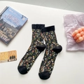 Floral crew socks for women featuring black sheer fabric with orange and white patterns - One Size / Black