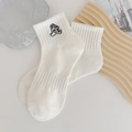 White crew socks featuring minimalist black cartoon character embroidery and ribbed cuffs - One Size / Cartoon Embroidery