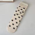 Chaussettes mi-mollet en tricot crème avec motifs nœuds noirs et texture côtelée - Taille unique / Nœud Crème