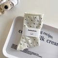 Creamy white crew socks with black polka dots and branded paper band packaging - One Size / Milk White