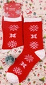 Detail view of red Christmas socks with white snowflake patterns and holiday gift tag - 37-43 / Red Snowflake