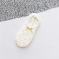 Detail van pluche fleece huissokken met blauwe stippen en een decoratieve gele strik - Eén maat / Witte Stippen