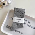Grey mid-calf socks with black polka dots and Suxinaimin paper wrap brand detail - One Size / Light Gray