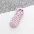 Detail view of purple striped fleece socks with bow and anti-slip silicone dots - One Size / Purple Striped