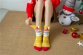 Detail of yellow coral fleece Christmas socks featuring 3D plush balls and Santa patterns - Yellow Santa Claus (No. 9)