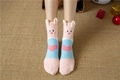 Detail of pink coral fleece socks with 3D pig ears and heart pattern on straw mat - Pink Blue Pig Heart (No. 3)