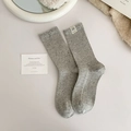 Light gray knit crew socks featuring vintage dog pattern label and textured speckled fabric - One Size / Light Gray